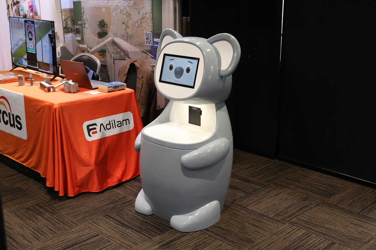 Full-length koala Arcus Self-Service Junior showing its checkout shelf, receipt printer and weighted base.